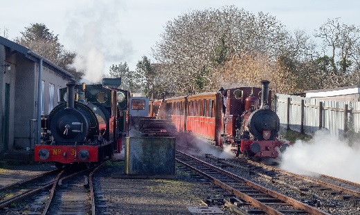 2 locomotives prepared in Pendre as a train steams past.