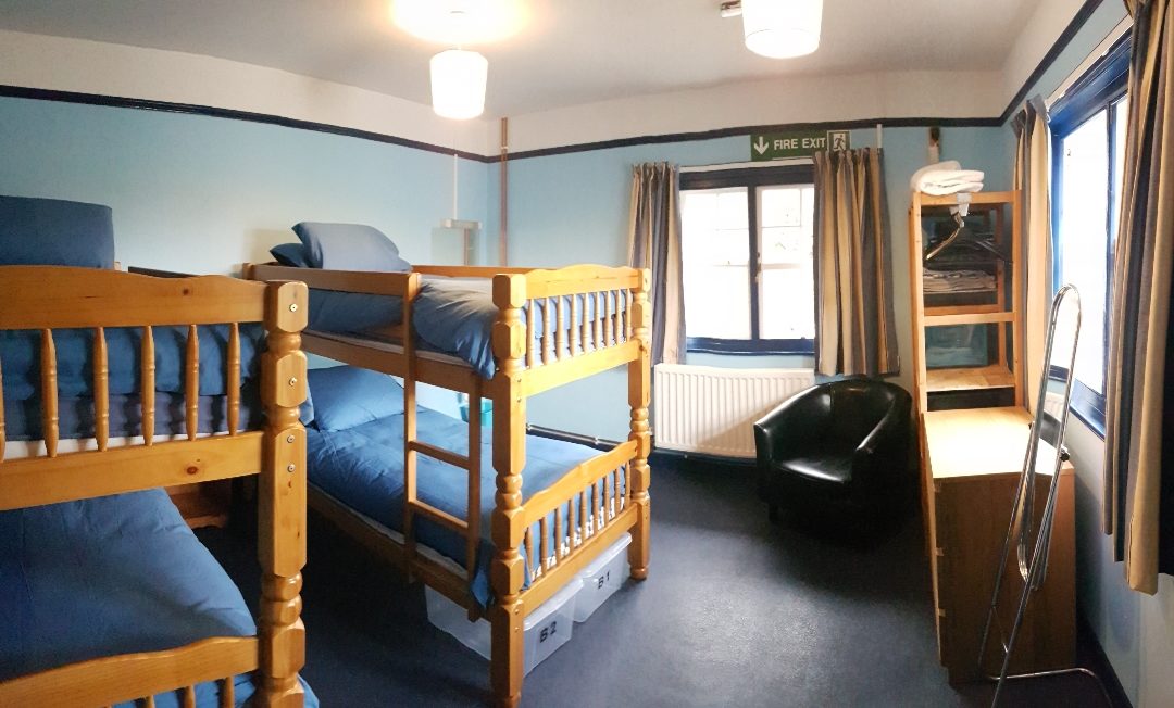 Wooden bunk beds in a naturally lit room