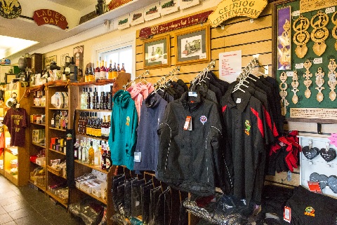 Talyllyn clothing hanging on racks in the gift shop.