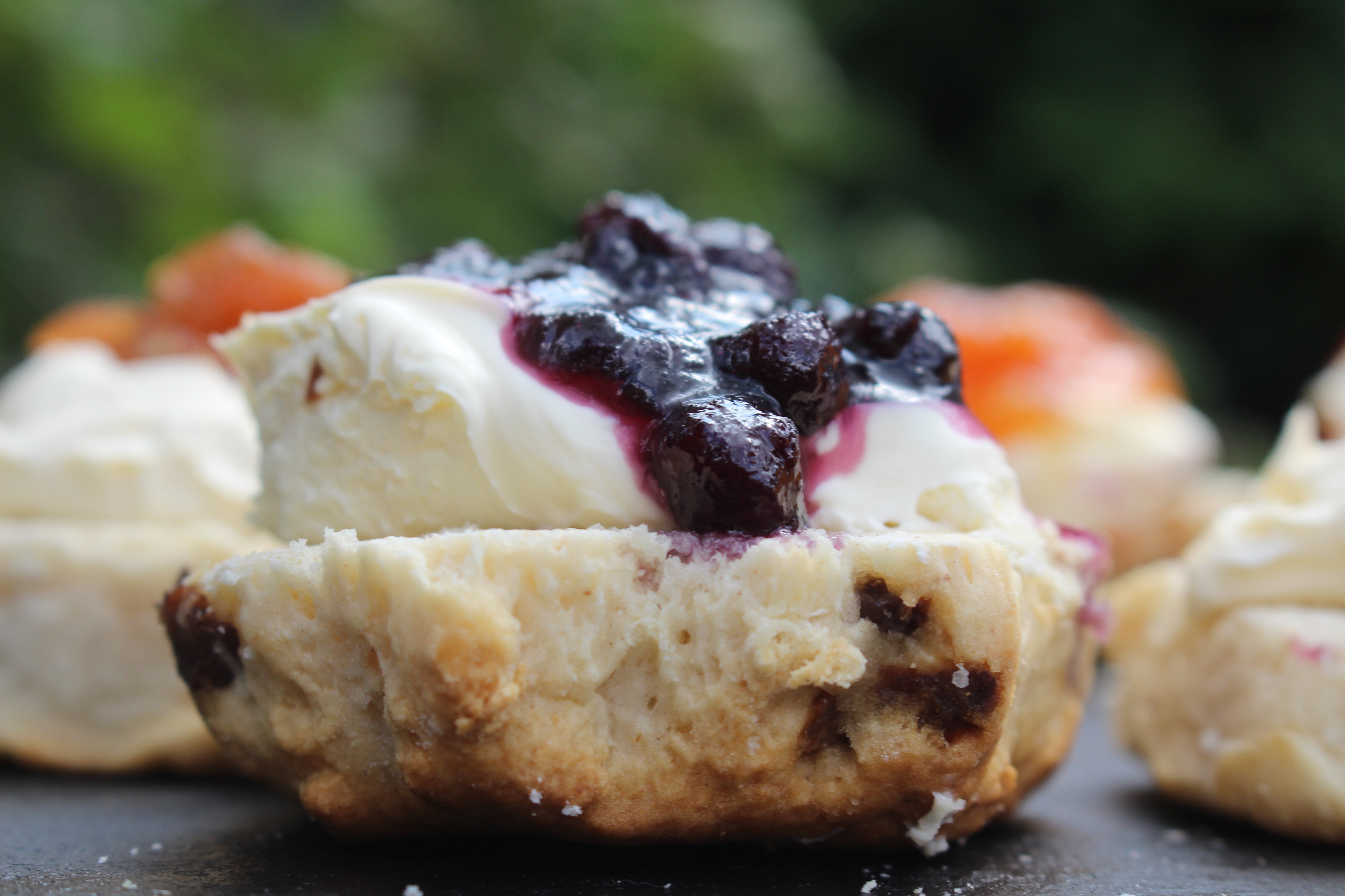 A scone coated in jam and cream