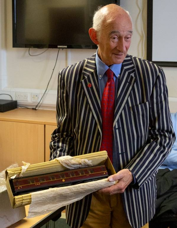 Paul Atterbury looking at a model railway carirage.