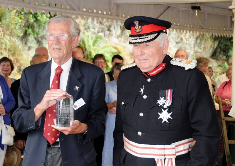 Richard Hope (left) in his role of President of the Talyllyn Railway Preservation Society being presented with the Queen’s Award For Voluntary Service by the then Lord-Lieutenant of Gwynedd, Huw Morgan Daniel (Right) on 26 July 2013.