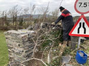 A man repairing a stone bridge.